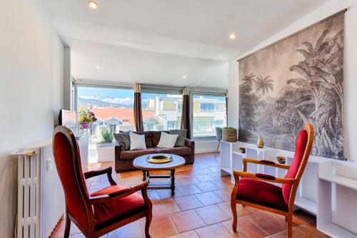 un salon avec un canapé, une table et des chaises dans l'établissement La terrasse de Rossini, à Nice