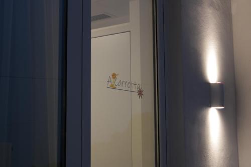 a door with a sign on it next to a mirror at Venere B&B Castelmola in Castelmola