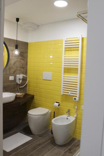 a bathroom with a white toilet and a sink at Venere B&B Castelmola in Castelmola