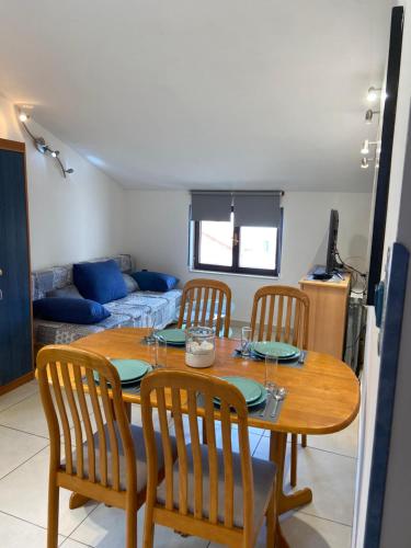 a dining room table and chairs in a living room at Apartments Mare in Pula
