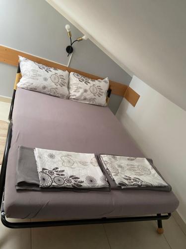 a bed with two pillows on it in a room at Apartments Mare in Pula