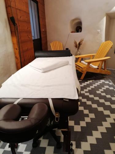 a bed and a chair in a room at Les Terres Rouges 06 in Guillaumes