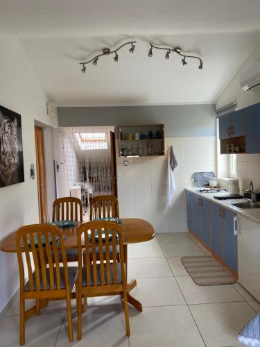 a kitchen with a wooden table and chairs and a table and a kitchen at Apartments Mare in Pula