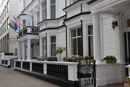 a row of white houses with flowerpots on their windows at Kilronan House in Dublin