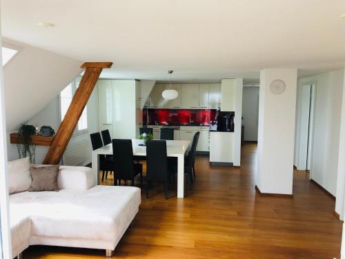 a living room with a white couch and a table at Apartment auf dem Bauernhof in Luzern