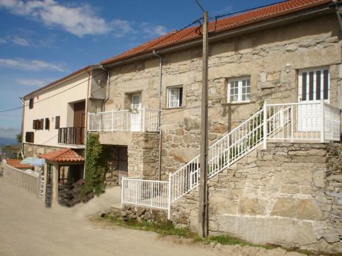 an old stone building with white stairs on it at O ROCHA in Paredes do Rio