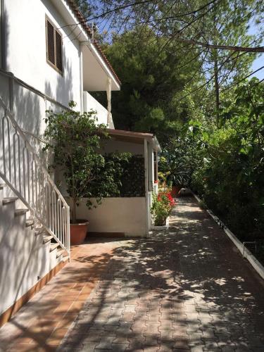 a walkway leading to a white house with a garage at Villa Irene in Vieste