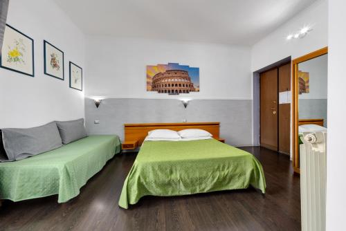 a bedroom with two beds with green sheets at Penelope Holiday in Rome