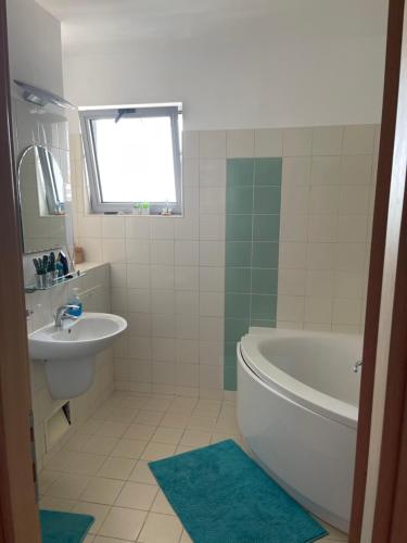 a bathroom with a white tub and a sink at Apartment Happiness by Nicole Jutka, visual artist Olimp in Olimp