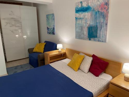 a small bedroom with a bed and a couch at Apartment Happiness by Nicole Jutka, visual artist Olimp in Olimp