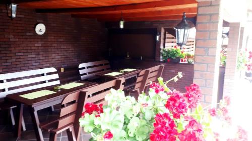 a table and chairs with flowers on a patio at Silva House in Deva