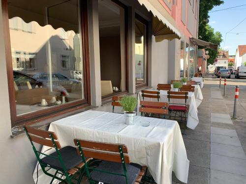 a white table and chairs on a patio at Hafner Hotel Apartment Self Check-In Anytime in Stuttgart