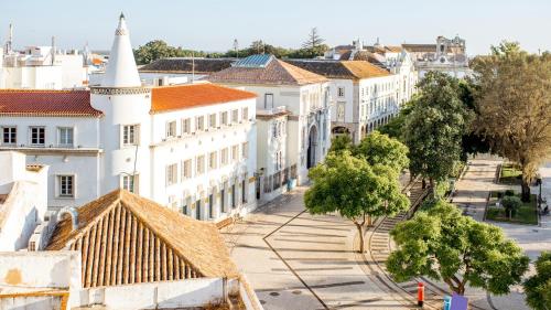 an aerial view of a city with white buildings at Tiny House Faro in Faro