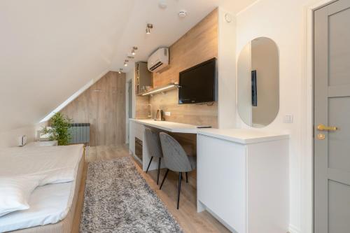 a bedroom with a bed and a desk with a tv at Põlva Maja apartments - contactless check-in in Põlva