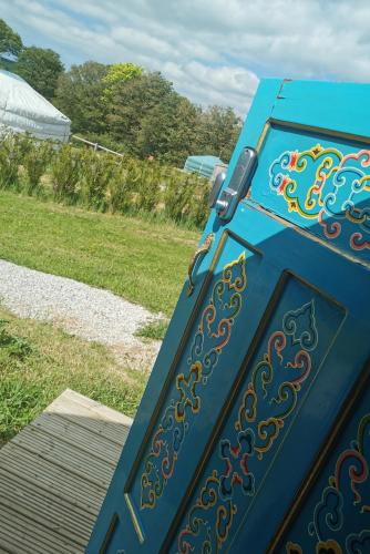 a blue door with a design on it at Glamping Yurts near Newquay in Newquay