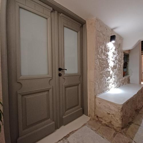 a door in a room with a stone wall at SYNNEFO - Home in the clouds in Exanthia