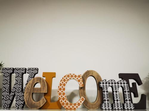 a wooden sign for the us open with a pretzel at Your comfy stay in the Center of Madrid in Madrid