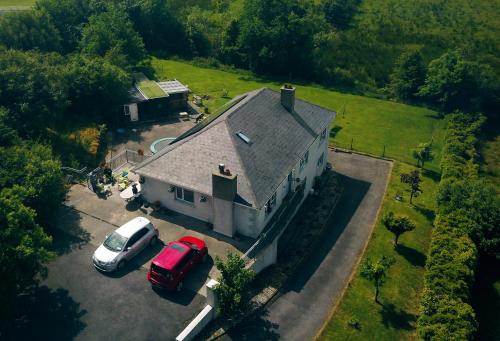 an aerial view of a house with two cars parked at Kilmagner in Letterkenny