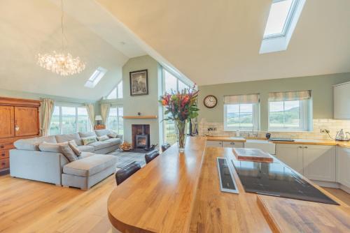 a kitchen and a living room with a wooden table at 8 Person-Luxury-FamilyFriendly-PetFriendly-Hot Tub in Hawick