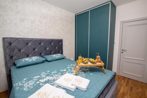 a bedroom with a bed with a table on it at Impressive Premium Apartment in Nikšić