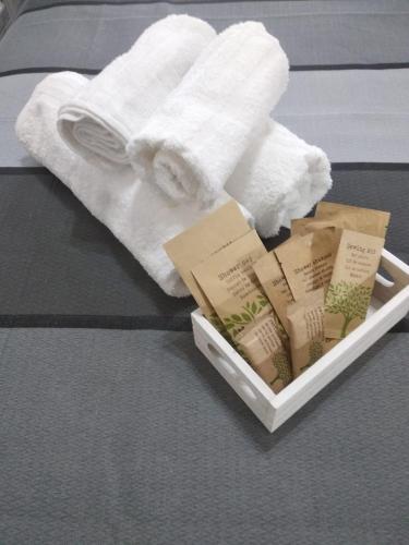 a tray with towels and books on a bed at B&B Domus Piedigrotta in Pizzo