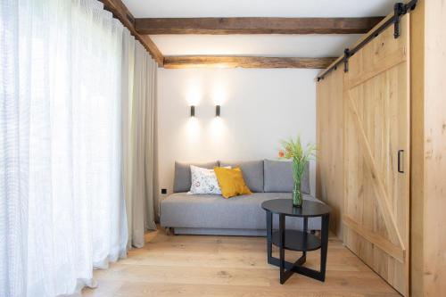 a living room with a couch and a table at House Troha - Rooms & Apartments in Bled