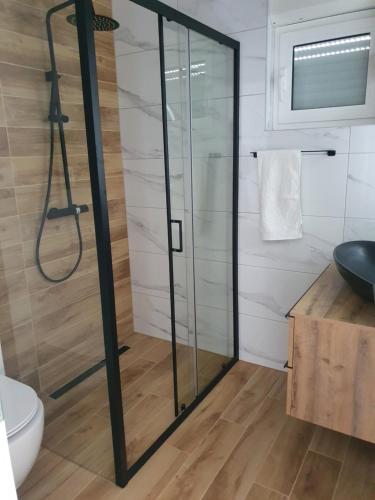 a glass shower in a bathroom with a toilet at LEGIN in Živogošće