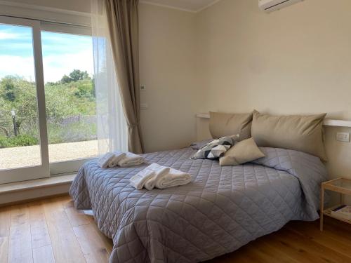 a bedroom with a bed with two towels on it at Podere Belsogno-Camera rosmarino in Montalcino