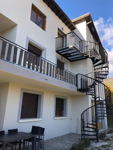 a building with stairs and a table and chairs at Les Apparts de la Tourronde in Chorges