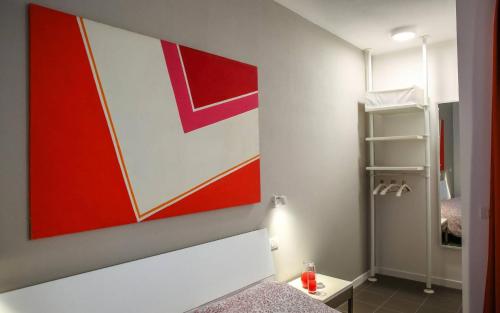 
a room with a white wall and a red wall at B&B WarmUp Grosseto in Grosseto
