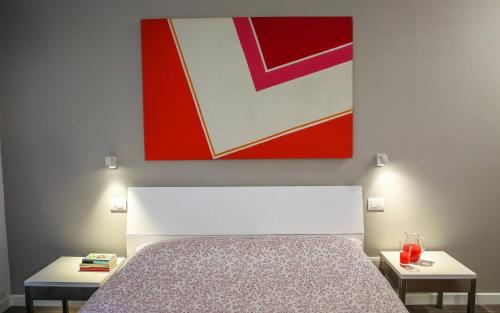 
a bed with a picture of a man on it at B&B WarmUp Grosseto in Grosseto
