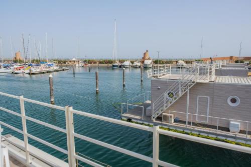 a dock with boats in a marina at House Boat Rimini Resort in Rimini