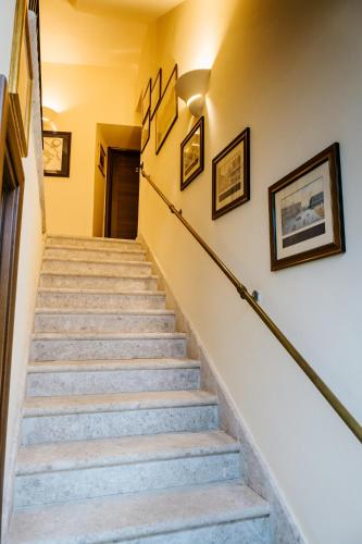 a set of stairs in a house with paintings on the walls at b&b Antiche Dimore Taurasi in Taurasi