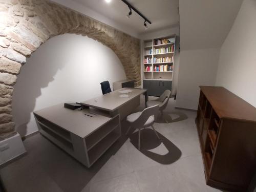 an office with a desk and a computer in a brick wall at Principe Rooms in Centola