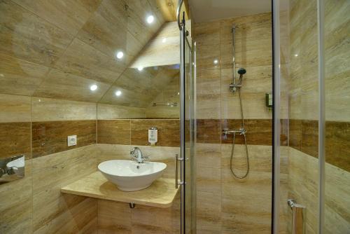 a bathroom with a sink and a shower at Dom Krawca - pod Chojnikiem in Jelenia Góra