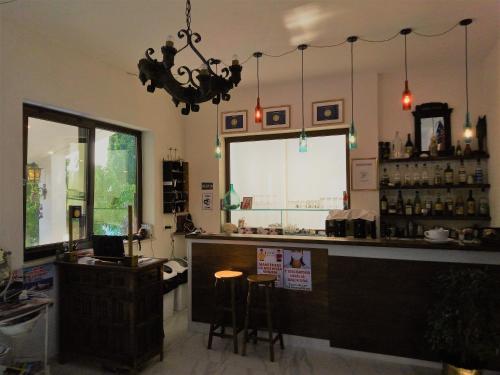 a restaurant with a bar with stools in a room at Vila Sejuda in Peschici