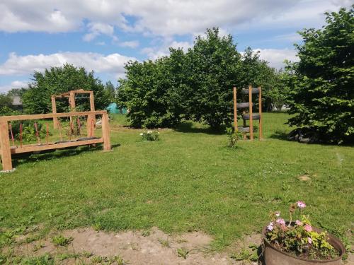 a park with a bench in the grass at Brīvupes in Balvi