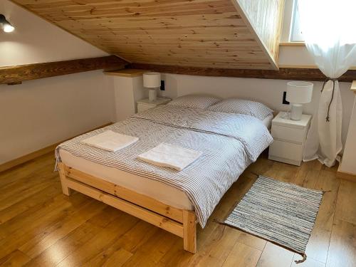 a bedroom with a large bed in a attic at Agroturystyka Widokówka Nielisz in Nielisz