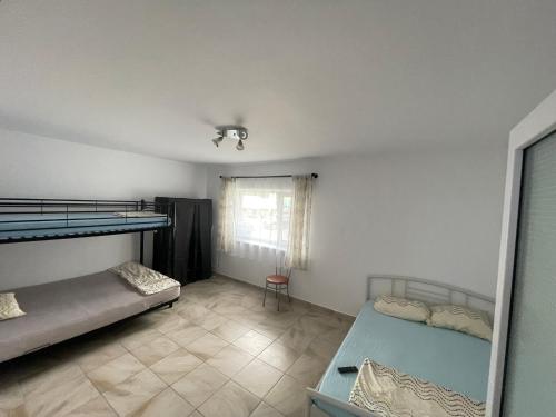a bedroom with two bunk beds and a window at Apartament Sofia in Costinesti