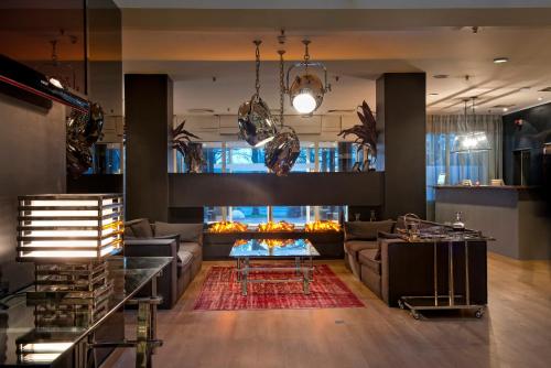 a living room with a couch and a fireplace at Wyndham Hannover Atrium in Hannover