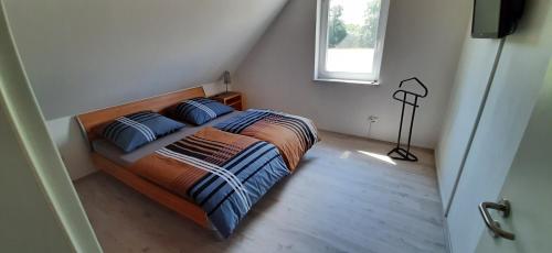 a bedroom with a bed with two pillows and a window at Am Habichtsweg in Lengerich