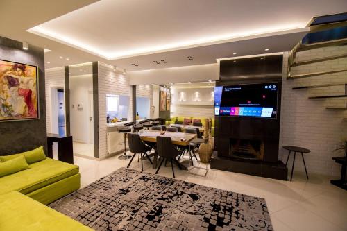 Helen Luxury Loft Design MEISONETTE-APARTMENT في أثينا: غرفة معيشة مع أريكة صفراء وغرفة طعام