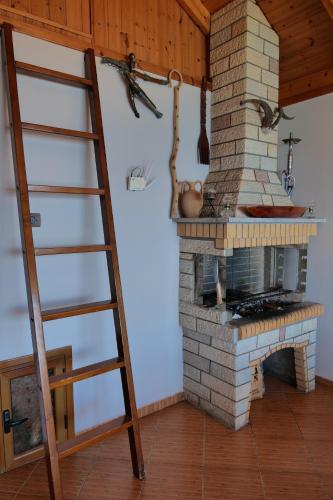 a ladder in a room with a brick oven at Villa Crystal in Sarandë