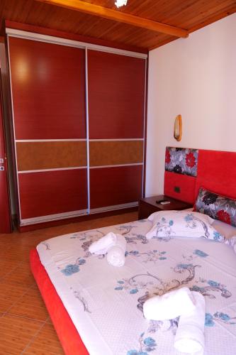 a bedroom with a large bed with towels on it at Villa Crystal in Sarandë