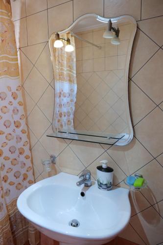 a bathroom with a sink and a mirror at Villa Crystal in Sarandë