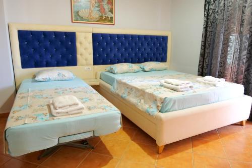 a bedroom with two beds with towels on them at Villa Crystal in Sarandë