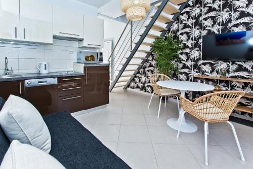 a kitchen and living room with a table and chairs at Luxurious Apartments Maslina with Beach in Hvar