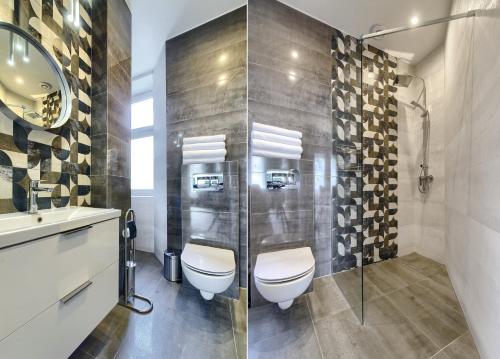 a bathroom with a toilet and a glass shower at Apartament Etiuda - ACCO RENT in Sopot