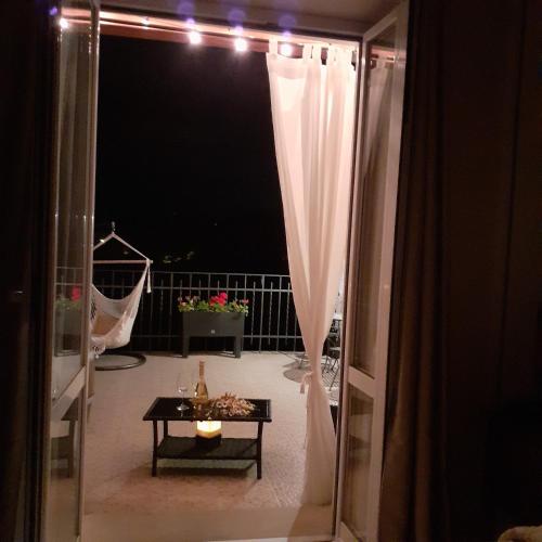 a room with a view of a balcony with a table at B&B Borgo Cortese in Gavi