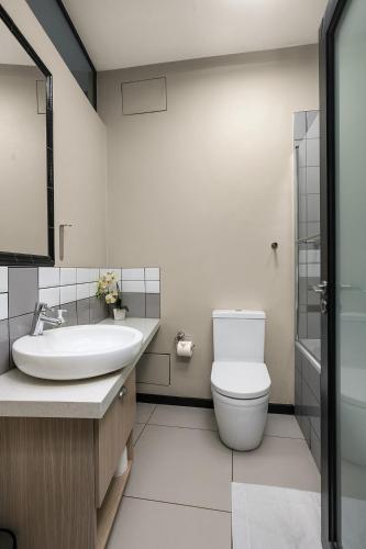 a bathroom with a toilet and a sink at Easy Stay - The Vantage Rosebank in Johannesburg